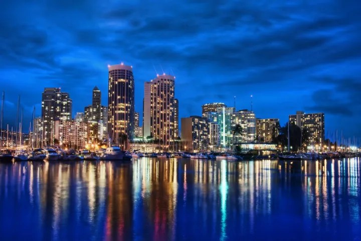 a body of water with a city in the background